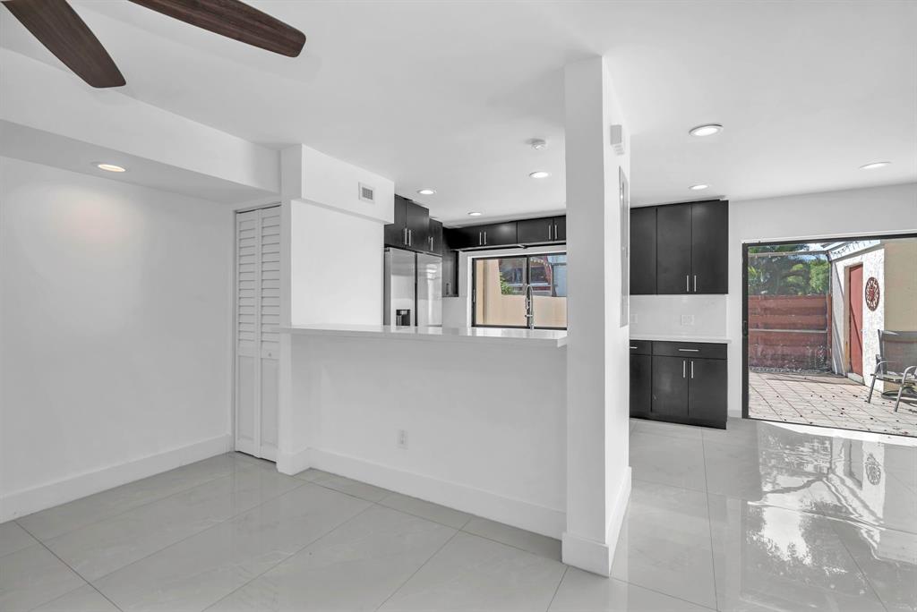 3896 Meadow Lane Hollywood, FL 33021 - Photo 9 of 33 an empty room with kitchen view and a window