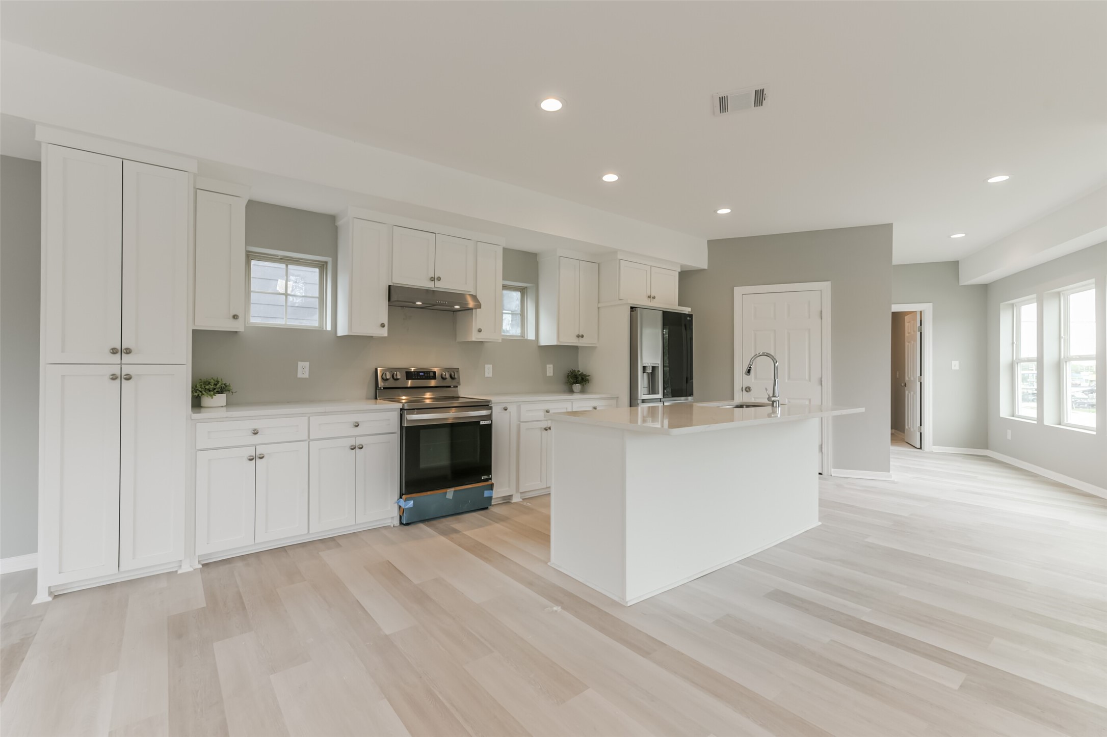 5302 Tarawa Road Houston, TX 77033 - Photo 3 of 35 a kitchen with white cabinets and stainless steel appliances