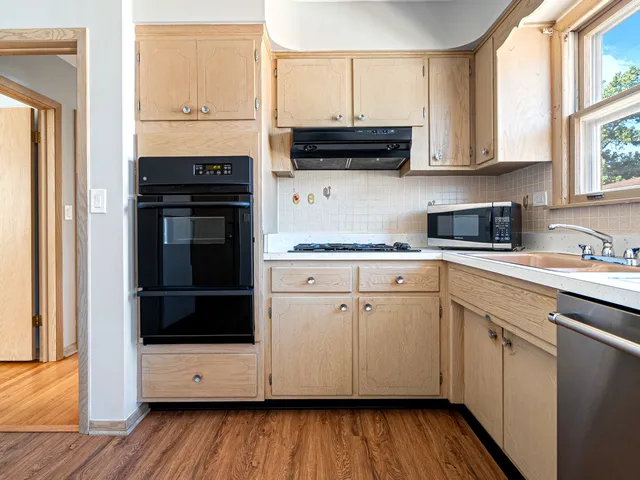 a kitchen with stainless steel appliances white cabinets and a granite counter tops