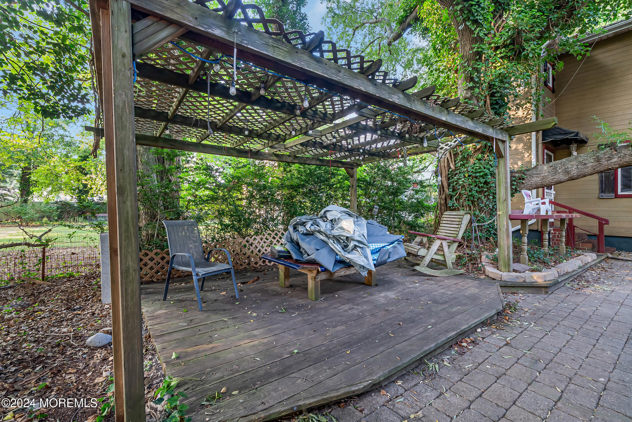 32 Woodrow Street Oakhurst, NJ 07755 - Photo 15 of 19 a view of a patio with table and chairs and wooden floor