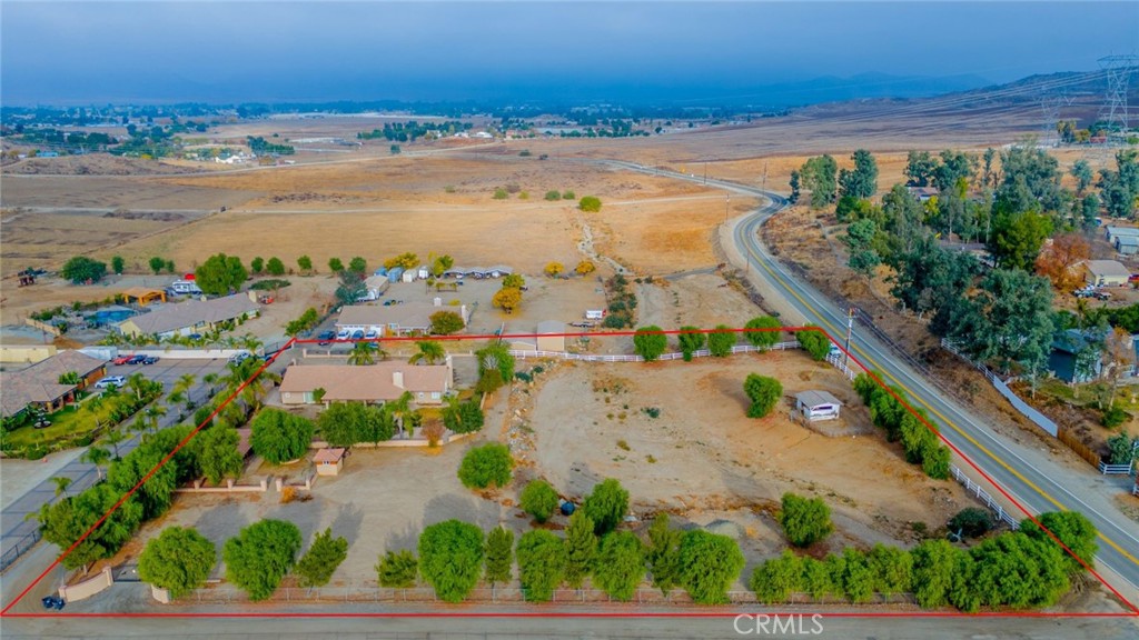 an aerial view of ocean and residential houses with outdoor space
