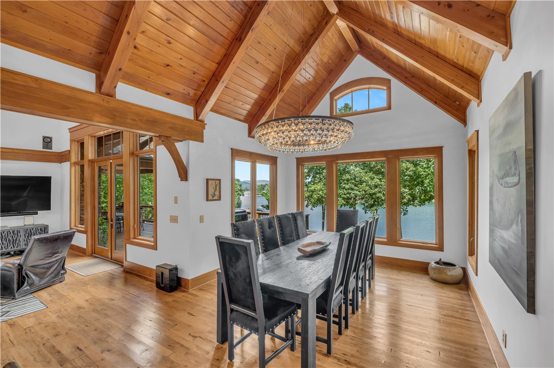 256 Talton Road Six Mile, SC 29682 - Photo 15 of 50 Dramatic vaulted wood ceilings and rich hardwood flooring frame serene lake views through tall windows.