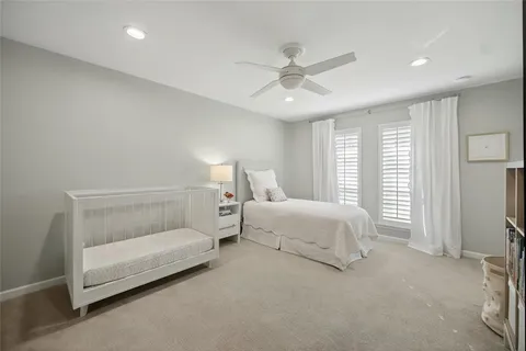a bed room with a bed and a ceiling fan