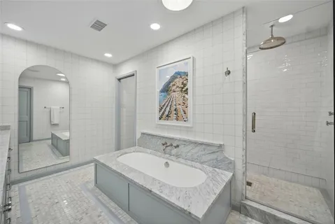 a bathroom with a bathtub and a sink