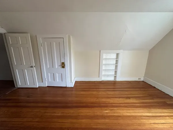a view of wooden floor and cabinet in a room