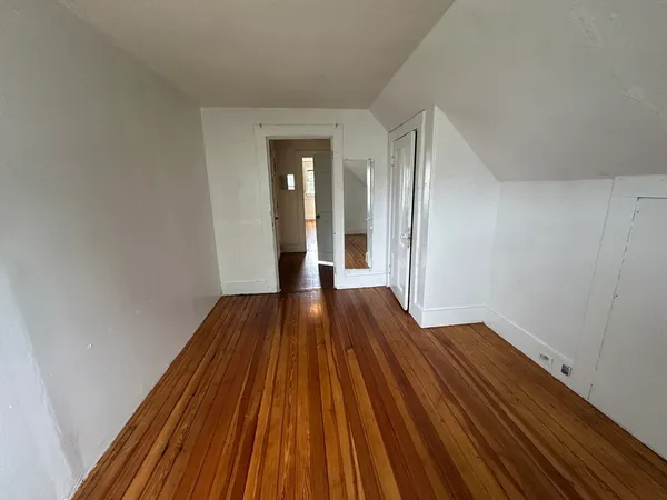 a view of a room with wooden floor and stairs