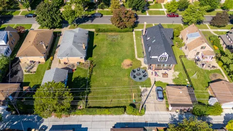 an aerial view of residential house with outdoor space and parking