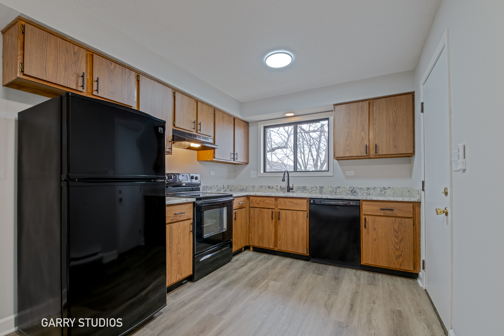 720 Briar Hill Lane, Unit 5 Addison, IL 60101 - Photo 2 of 14 a kitchen with granite countertop stainless steel appliances a refrigerator cabinets and wooden floor