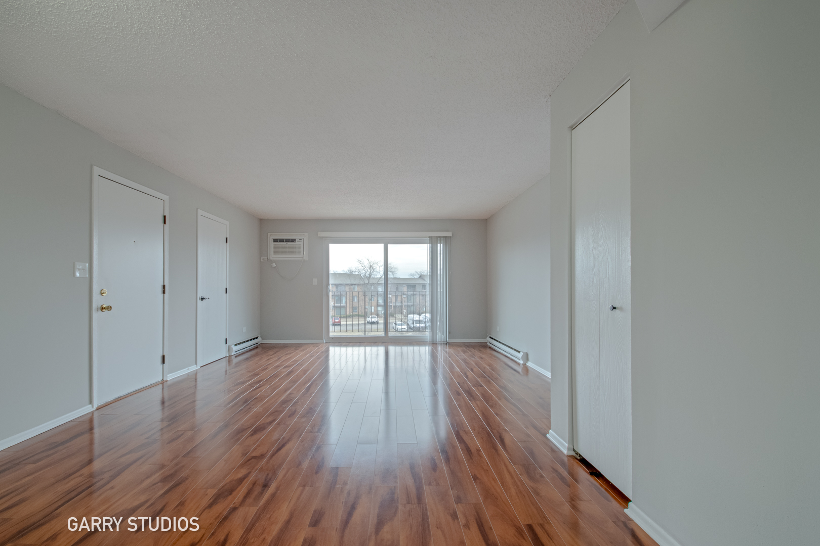 720 Briar Hill Lane, Unit 5 Addison, IL 60101 - Photo 4 of 14 a view of an empty room with wooden floor and a window