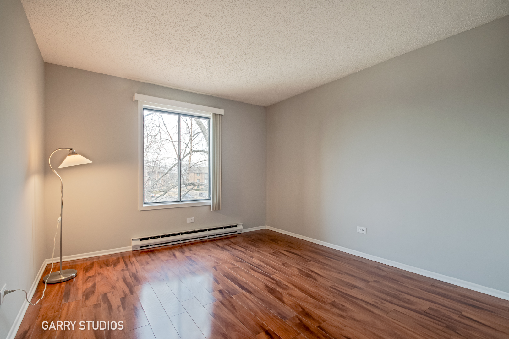 720 Briar Hill Lane, Unit 5 Addison, IL 60101 - Photo 10 of 14 a view of empty room with wooden floor and fan