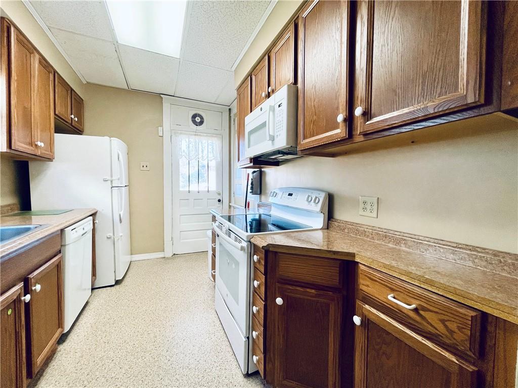 119 East Coffee Street Uniontown, PA 15401 - Photo 13 of 25 a kitchen with stainless steel appliances granite countertop a refrigerator a stove and a sink with wooden cabinets