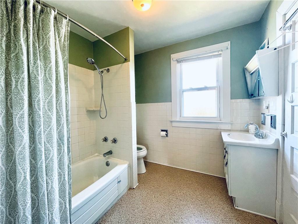 119 East Coffee Street Uniontown, PA 15401 - Photo 22 of 25 a bathroom with a bathtub a sink a window and a shower