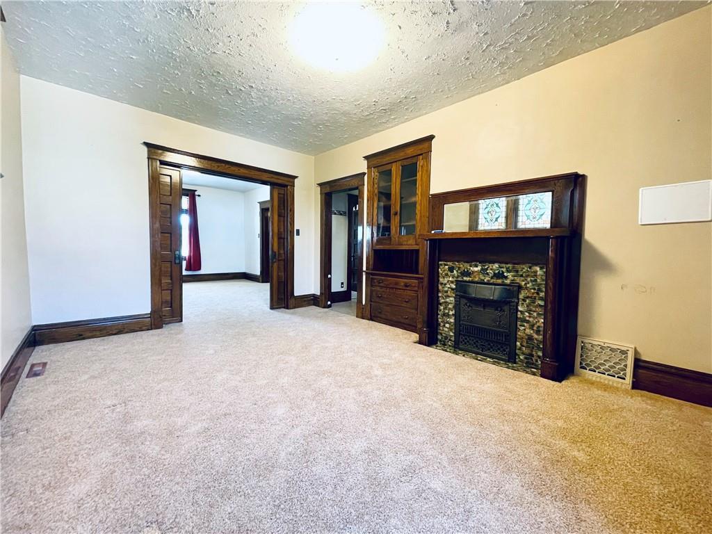119 East Coffee Street Uniontown, PA 15401 - Photo 9 of 25 a view of an empty room with a fireplace and a window