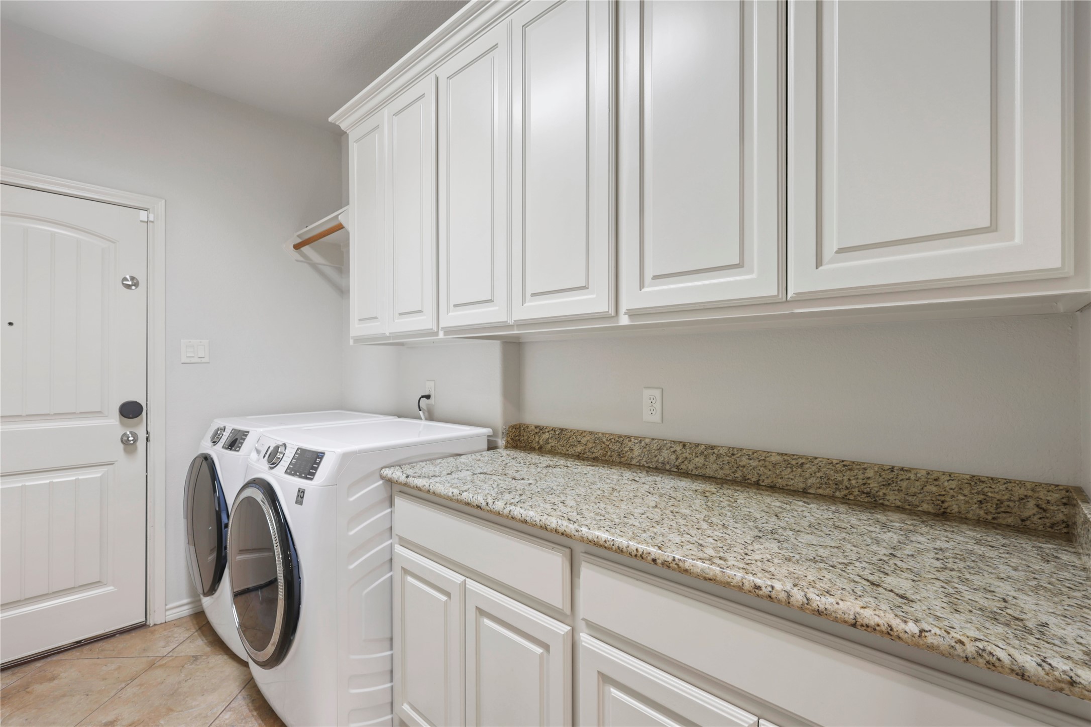 3801 Harvey Road College Station, TX 77845 - Photo 17 of 29 a utility room with granite countertop cabinets washer and dryer
