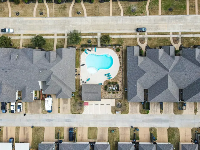 an aerial view of residential houses with outdoor space