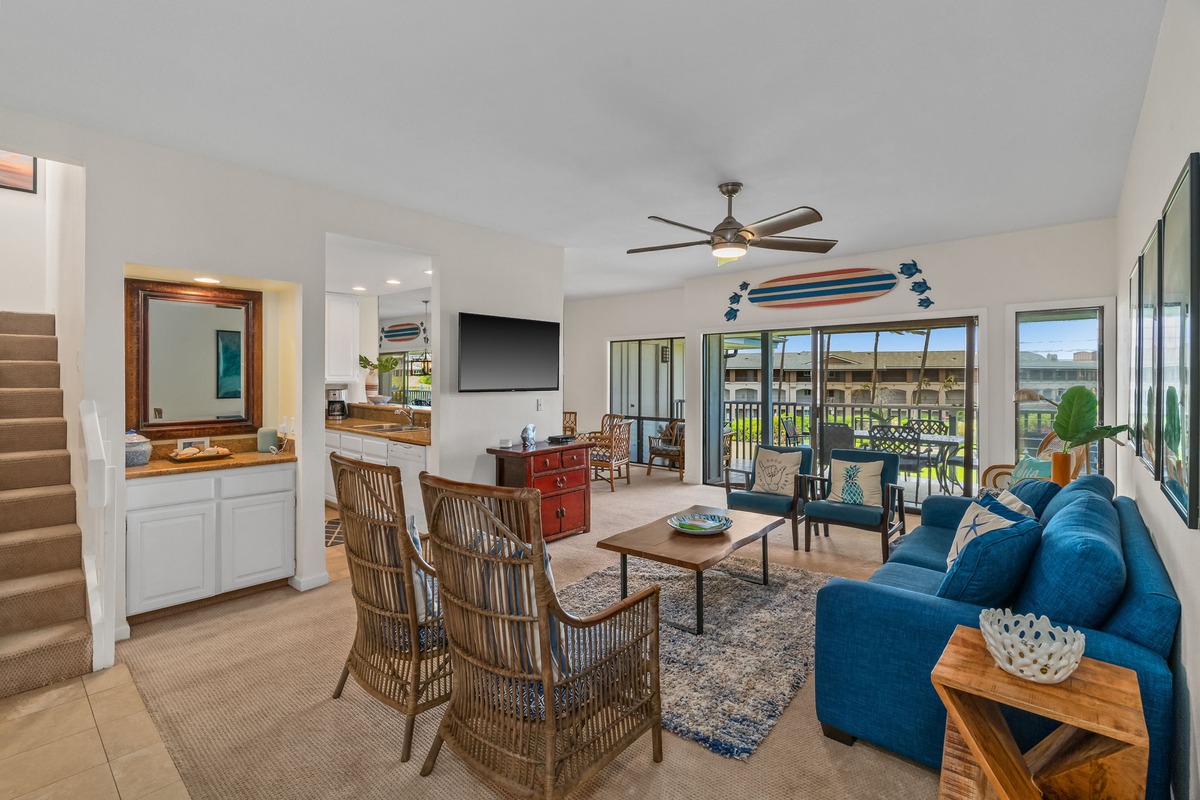 1565 Pe'e Road, Unit 422 Koloa, HI 96756 - Photo 3 of 22 a living room with furniture a flat screen tv and a large window