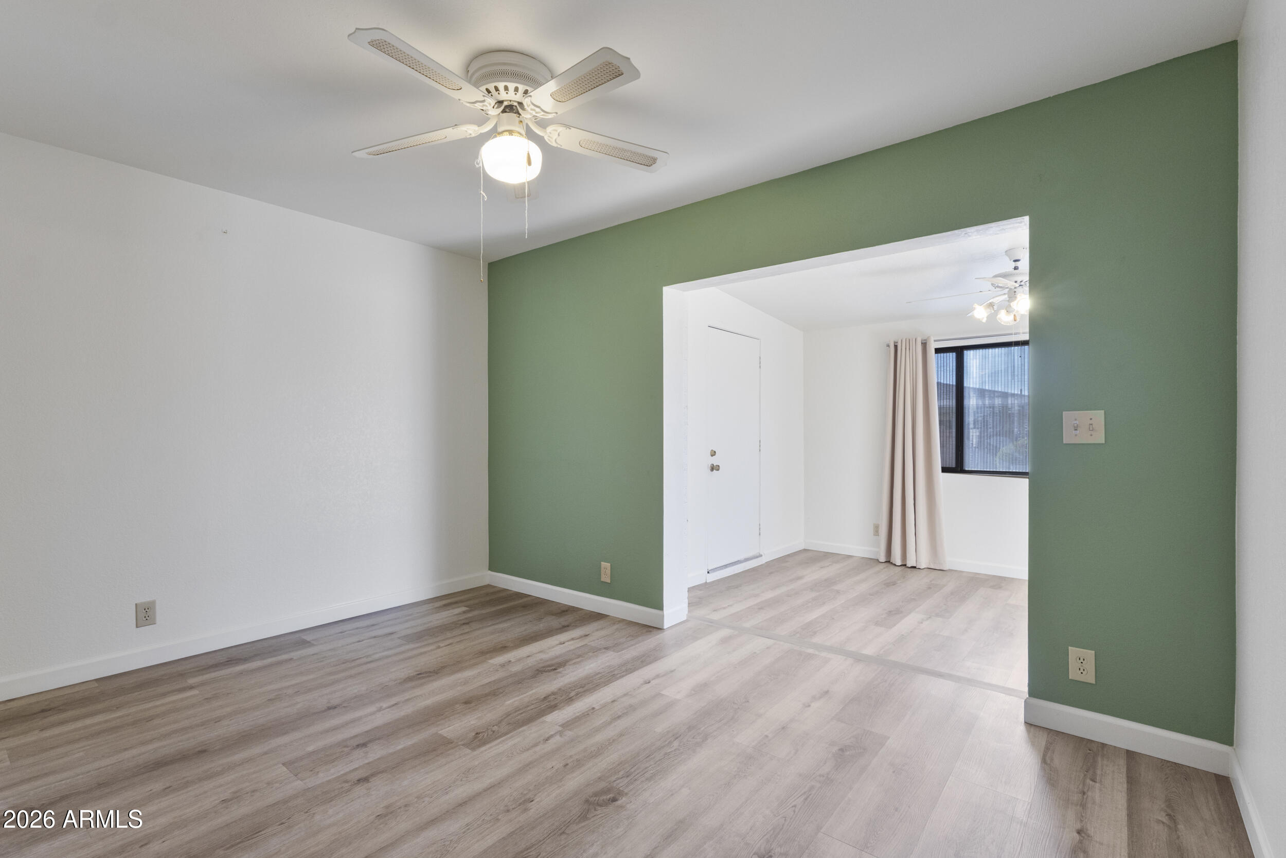 520 South Greenfield Road, Unit 39 Mesa, AZ 85206 - Photo 11 of 27 a view of an empty room with wooden floor