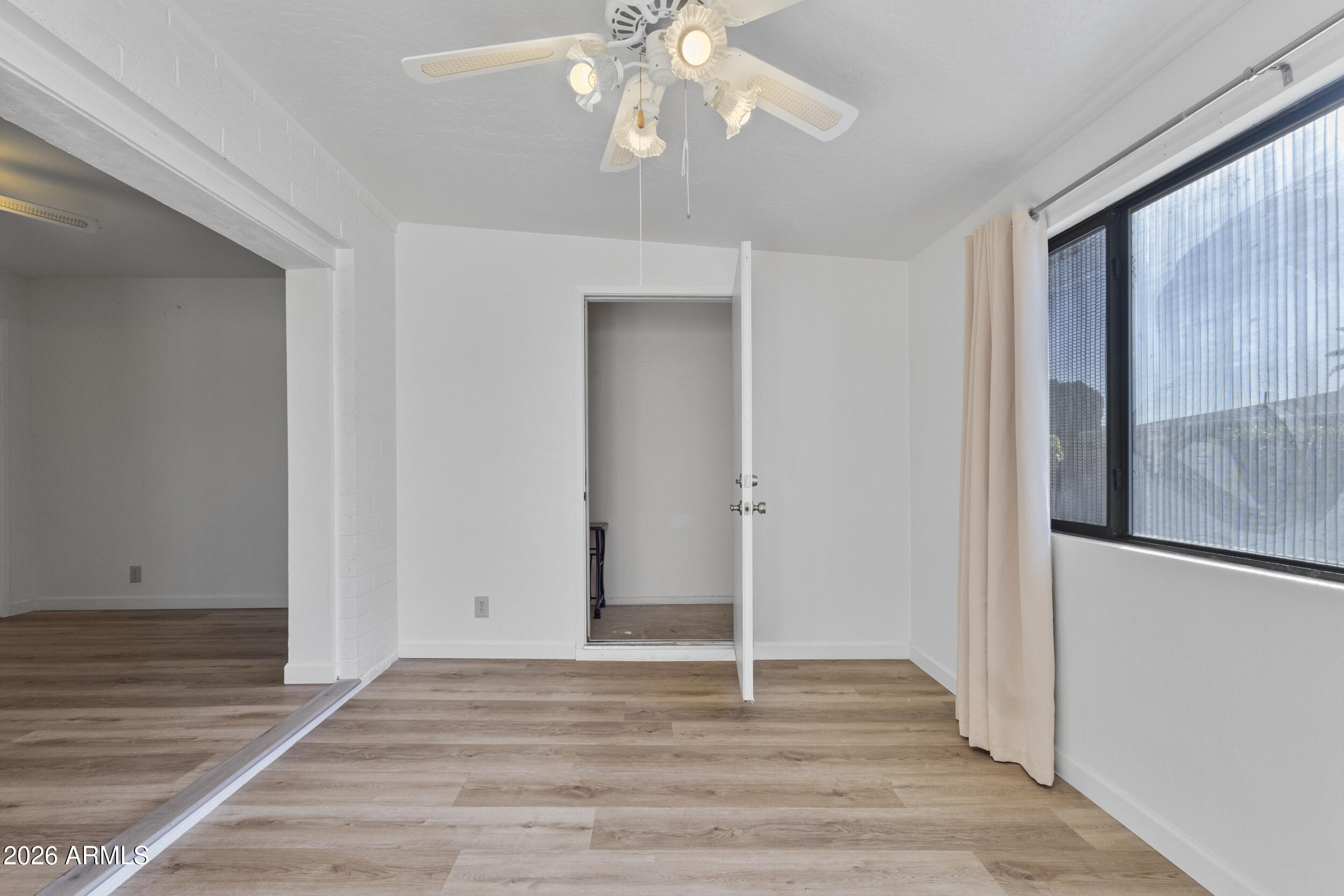 520 South Greenfield Road, Unit 39 Mesa, AZ 85206 - Photo 13 of 27 a view of an empty room with wooden floor and fan