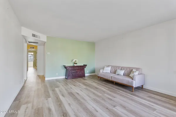 a living room with furniture and wooden floor