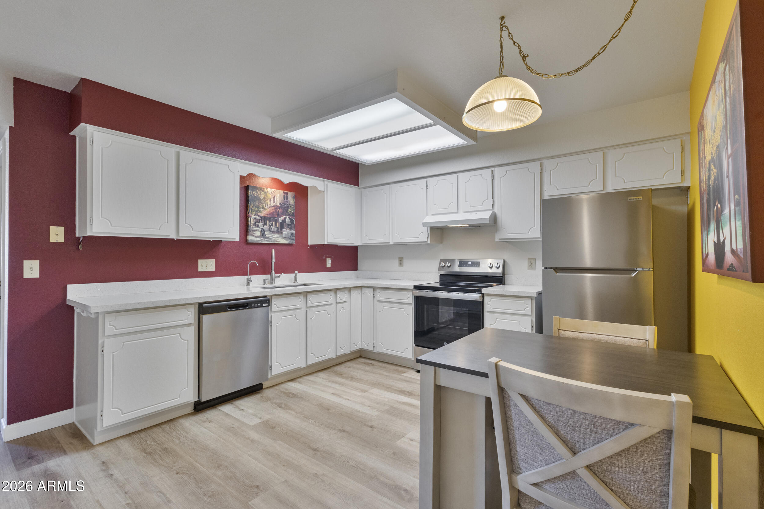 520 South Greenfield Road, Unit 39 Mesa, AZ 85206 - Photo 8 of 27 a kitchen with granite countertop white cabinets and stainless steel appliances