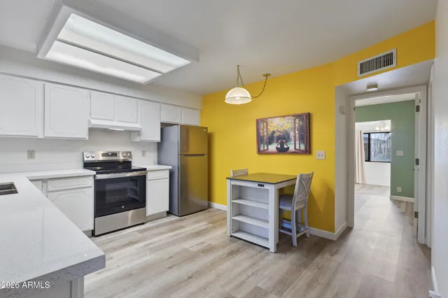 a kitchen with stainless steel appliances granite countertop a stove and a refrigerator
