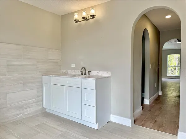 a bathroom with a shower sink and mirror