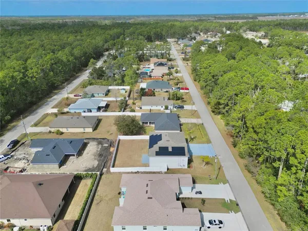 an aerial view of a residential houses with outdoor space