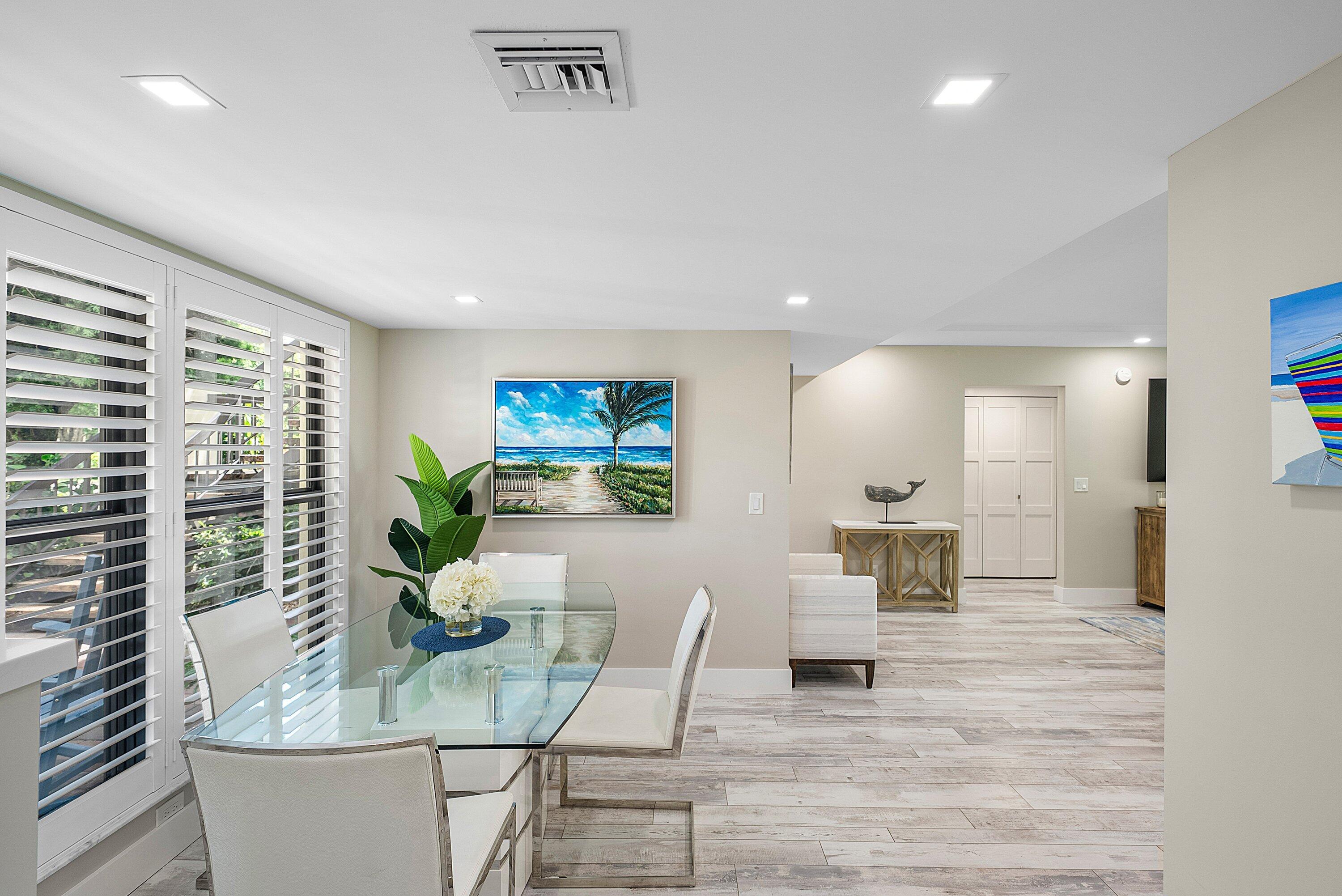 3709 North Quail Ridge Drive, Unit BOBWHITE B Boynton Beach, FL 33436 - Photo 12 of 51 a living room with furniture a large window and a wooden floor