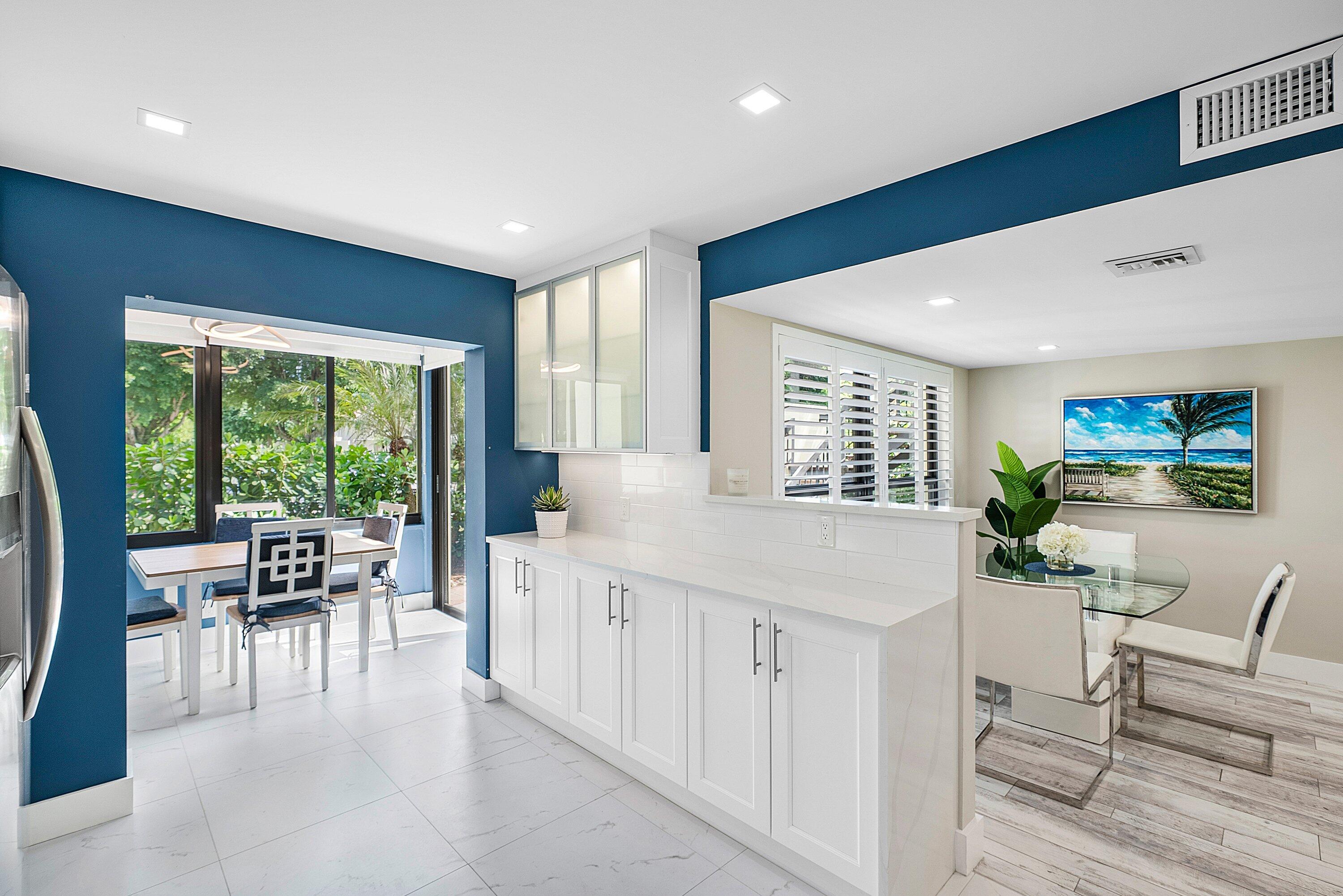 3709 North Quail Ridge Drive, Unit BOBWHITE B Boynton Beach, FL 33436 - Photo 13 of 51 a living room with furniture a flat screen tv and a large window