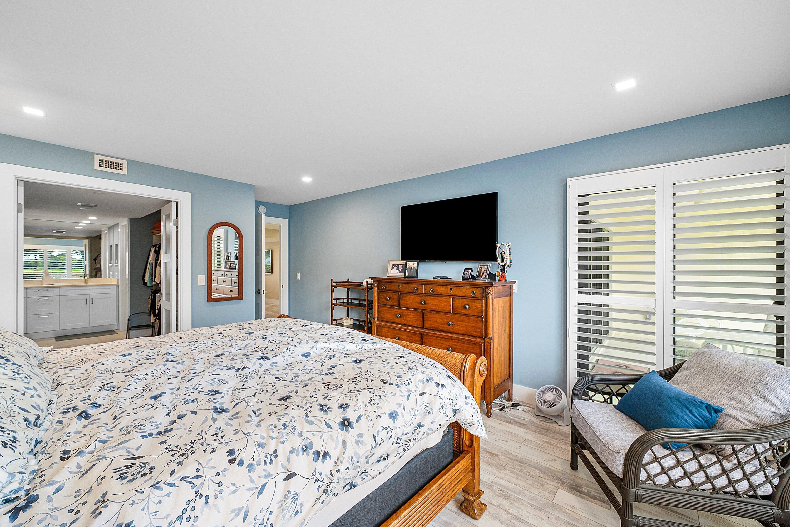 3709 North Quail Ridge Drive, Unit BOBWHITE B Boynton Beach, FL 33436 - Photo 17 of 51 a bedroom with a bed and a flat screen tv