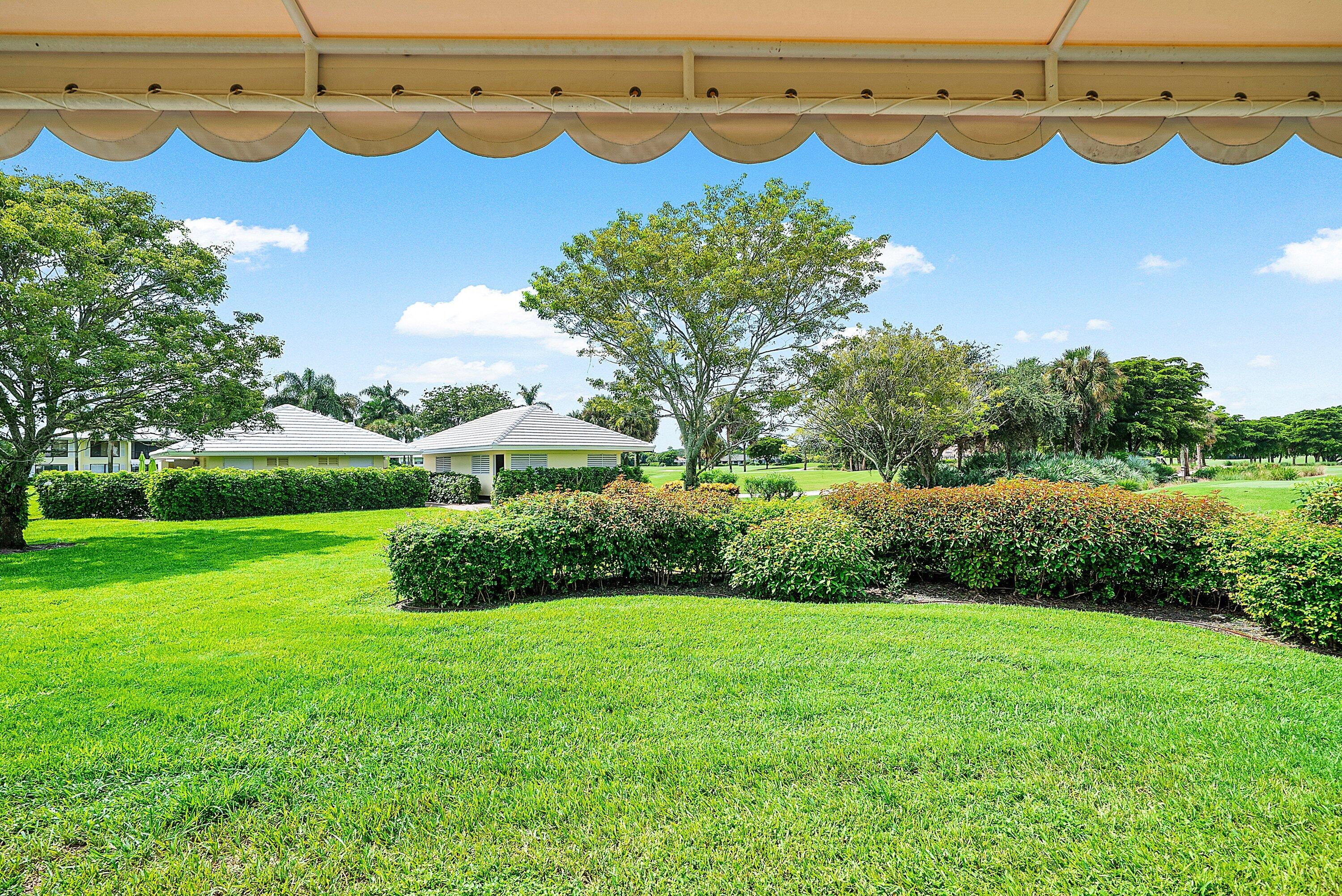 3709 North Quail Ridge Drive, Unit BOBWHITE B Boynton Beach, FL 33436 - Photo 28 of 51 a view of a garden with lawn chairs