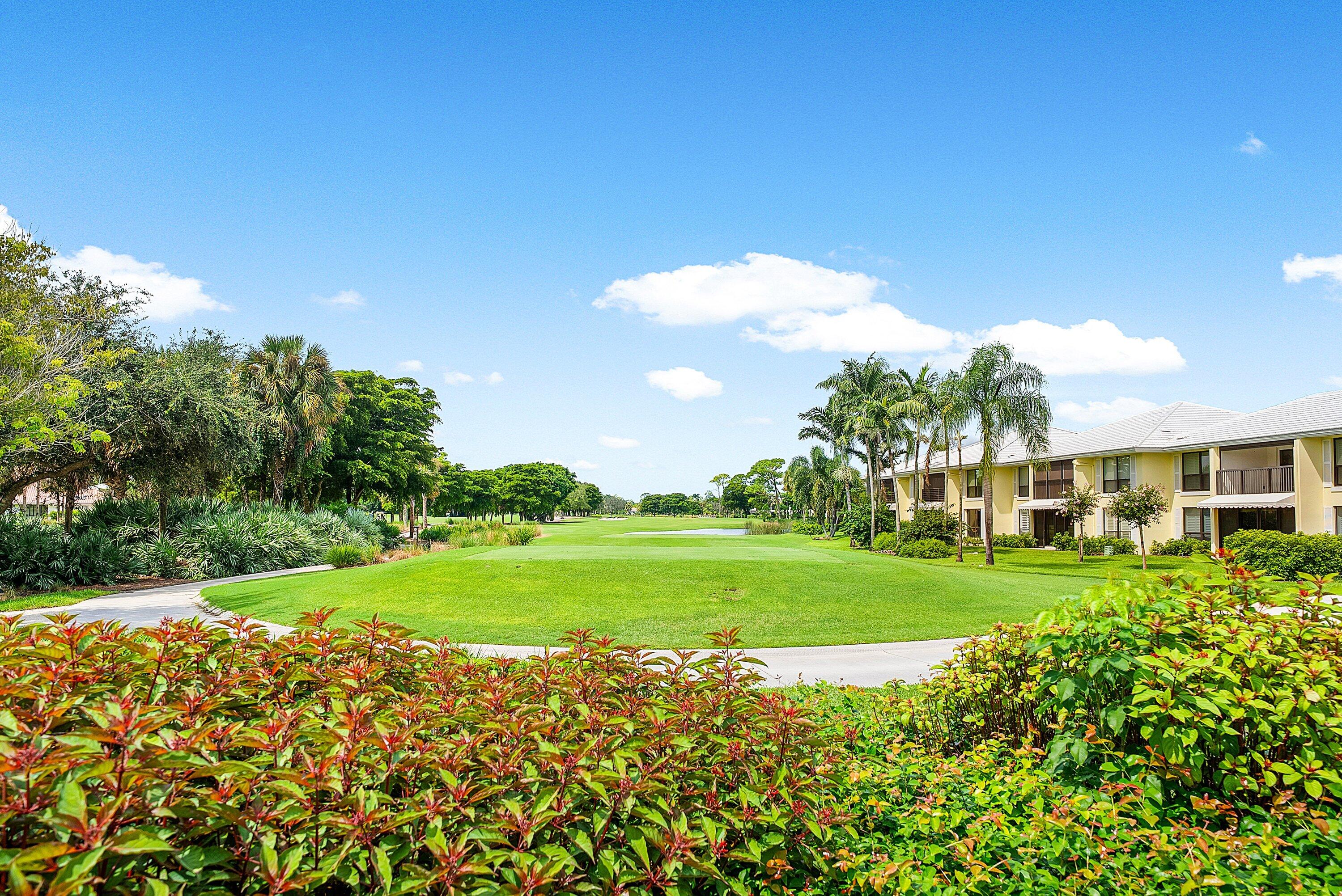 3709 North Quail Ridge Drive, Unit BOBWHITE B Boynton Beach, FL 33436 - Photo 29 of 51 a view of a big yard with a large tree and a plant