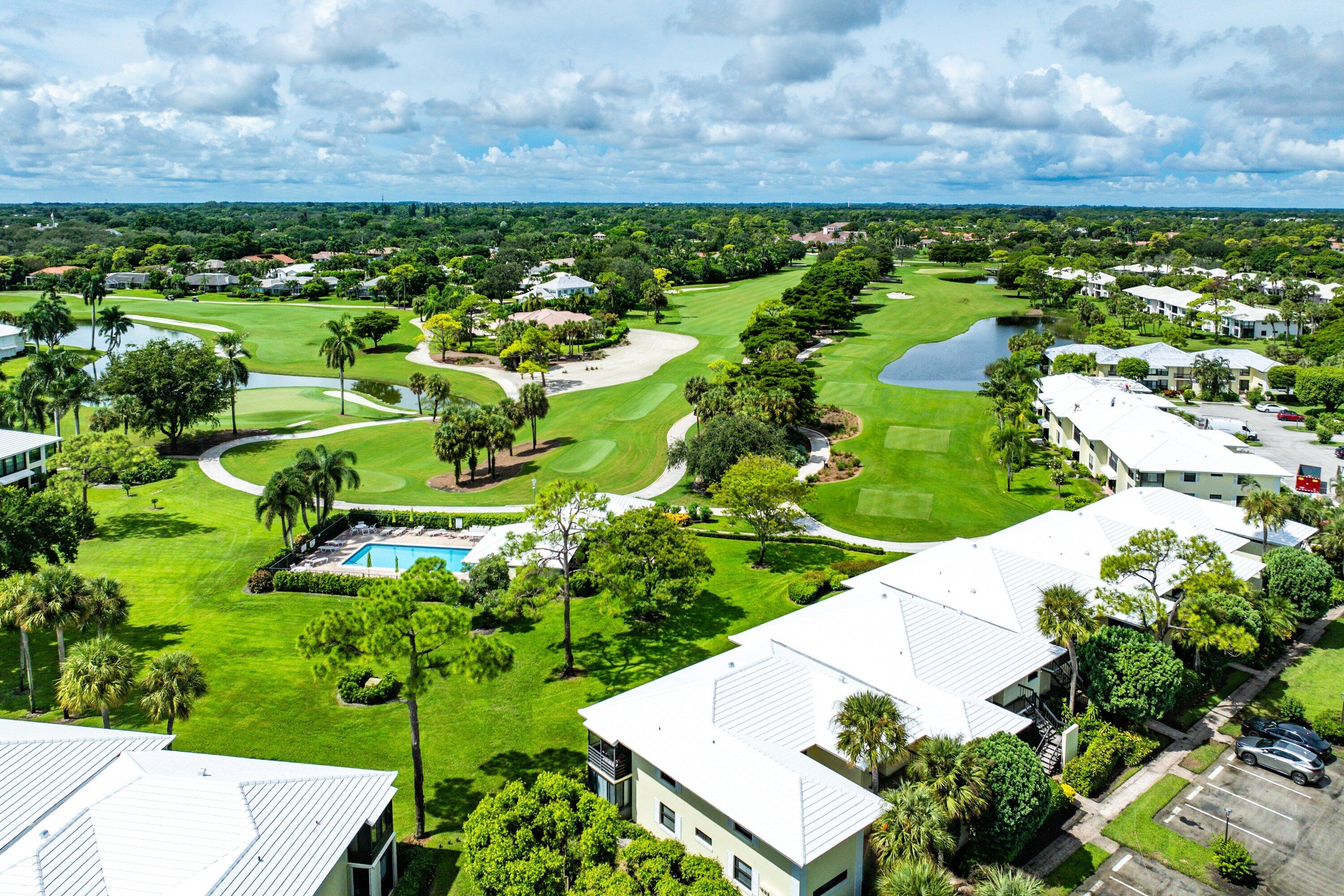 3709 North Quail Ridge Drive, Unit BOBWHITE B Boynton Beach, FL 33436 - Photo 30 of 51 a view of a lake with a building in the background