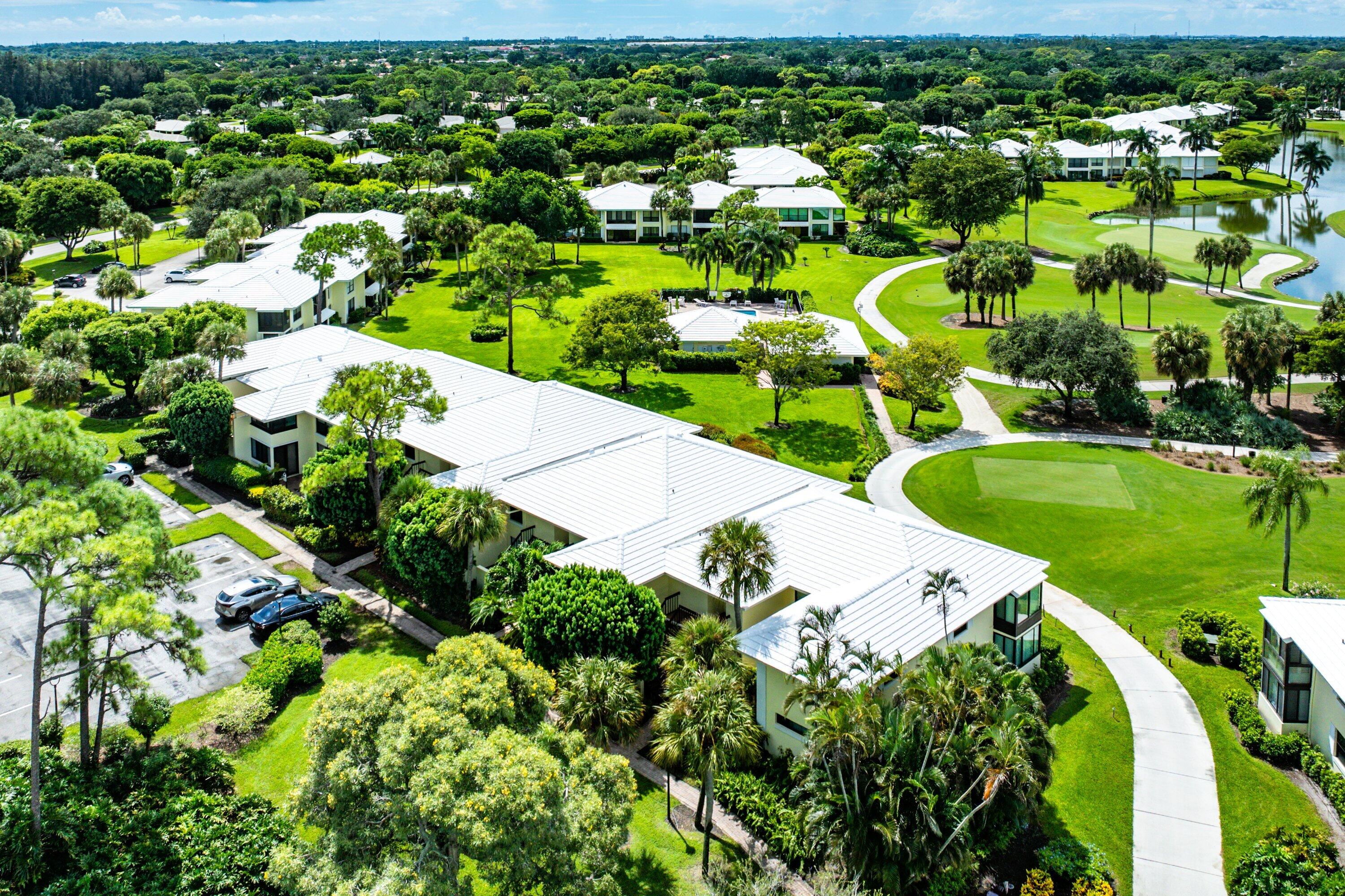 3709 North Quail Ridge Drive, Unit BOBWHITE B Boynton Beach, FL 33436 - Photo 31 of 51 a view of a swimming pool with a garden