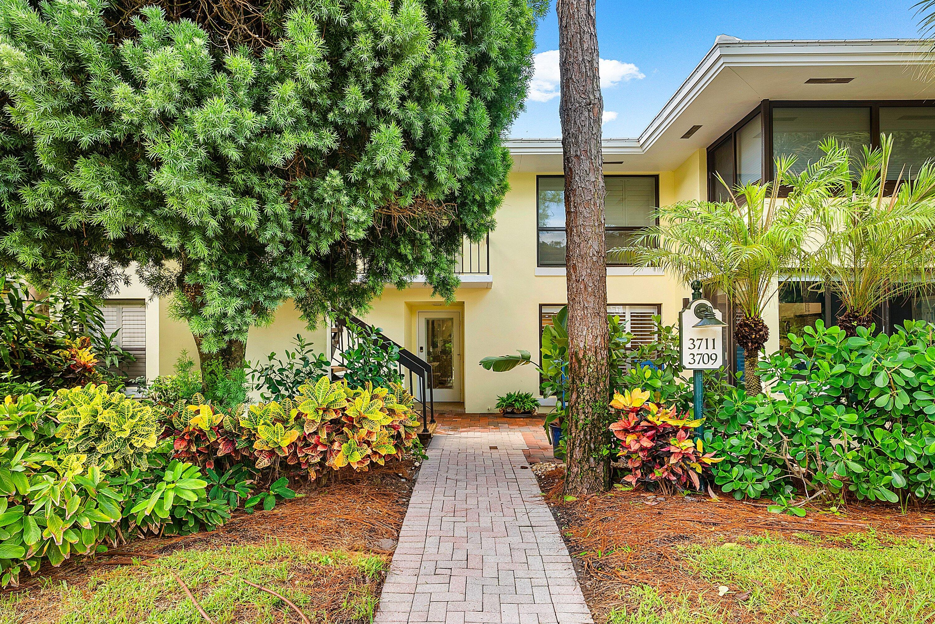 3709 North Quail Ridge Drive, Unit BOBWHITE B Boynton Beach, FL 33436 - Photo 38 of 51 a front view of a house having a yard