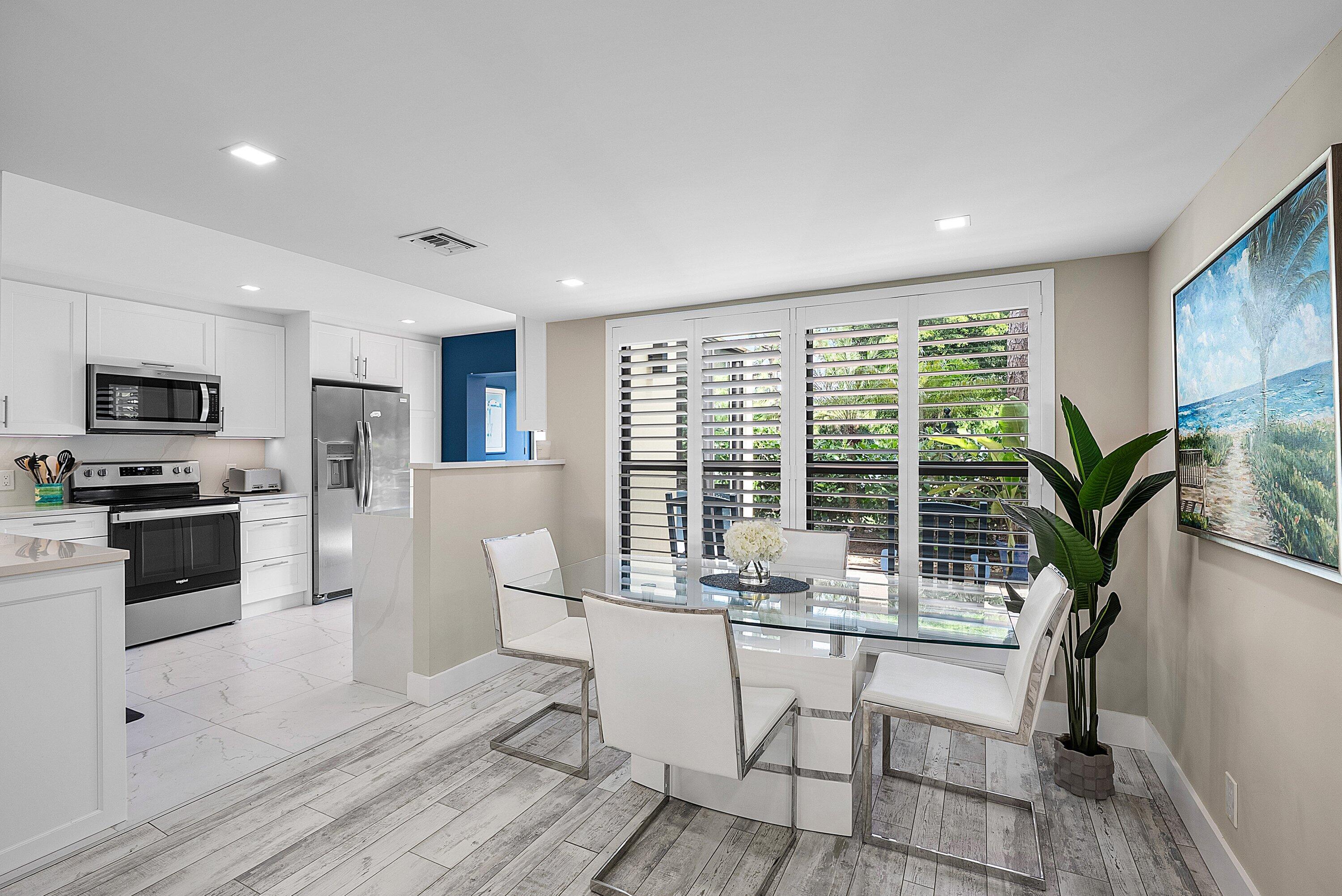 3709 North Quail Ridge Drive, Unit BOBWHITE B Boynton Beach, FL 33436 - Photo 4 of 51 a dining room with furniture and large windows