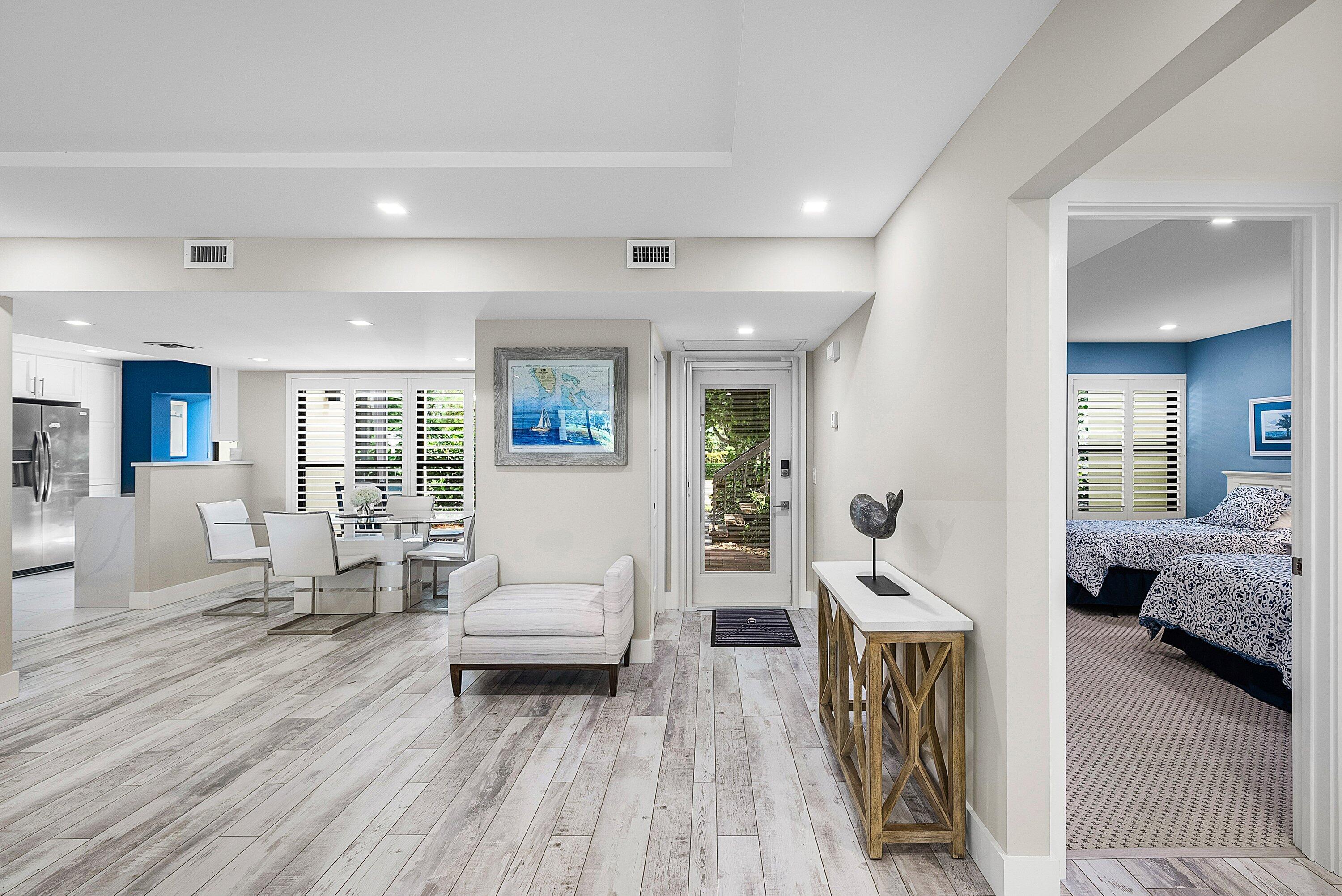 3709 North Quail Ridge Drive, Unit BOBWHITE B Boynton Beach, FL 33436 - Photo 5 of 51 a living room with furniture and a wooden floor