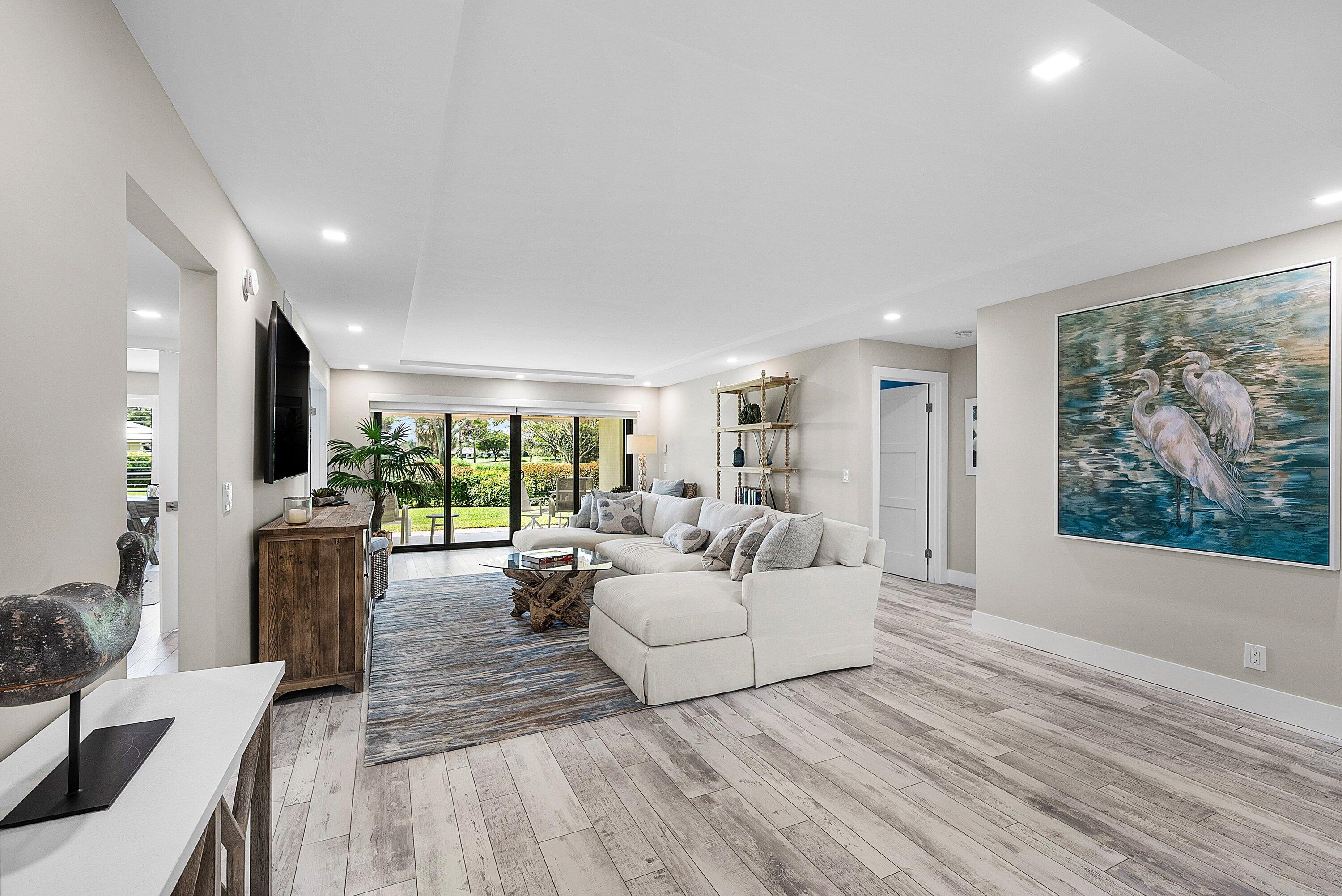 3709 North Quail Ridge Drive, Unit BOBWHITE B Boynton Beach, FL 33436 - Photo 6 of 51 a living room with furniture and a large window