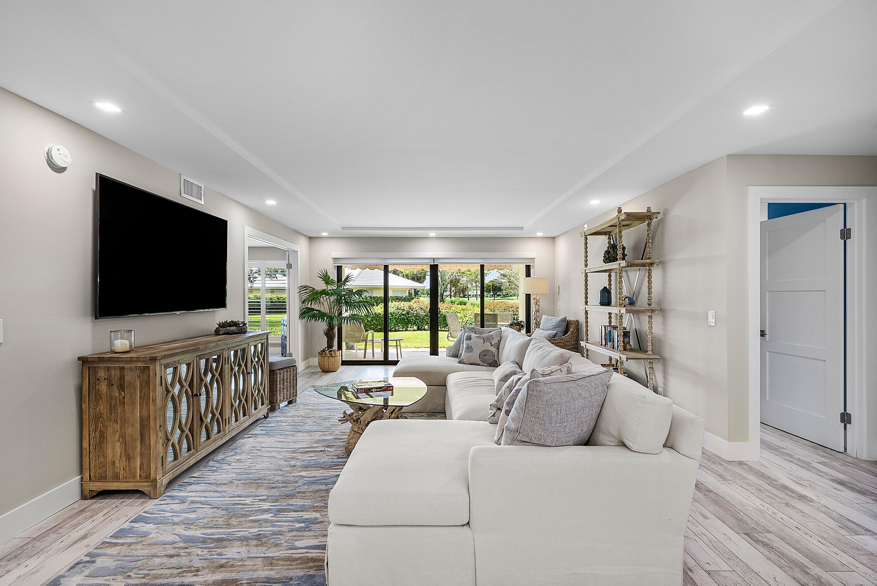 3709 North Quail Ridge Drive, Unit BOBWHITE B Boynton Beach, FL 33436 - Photo 7 of 51 a living room with furniture and a flat screen tv