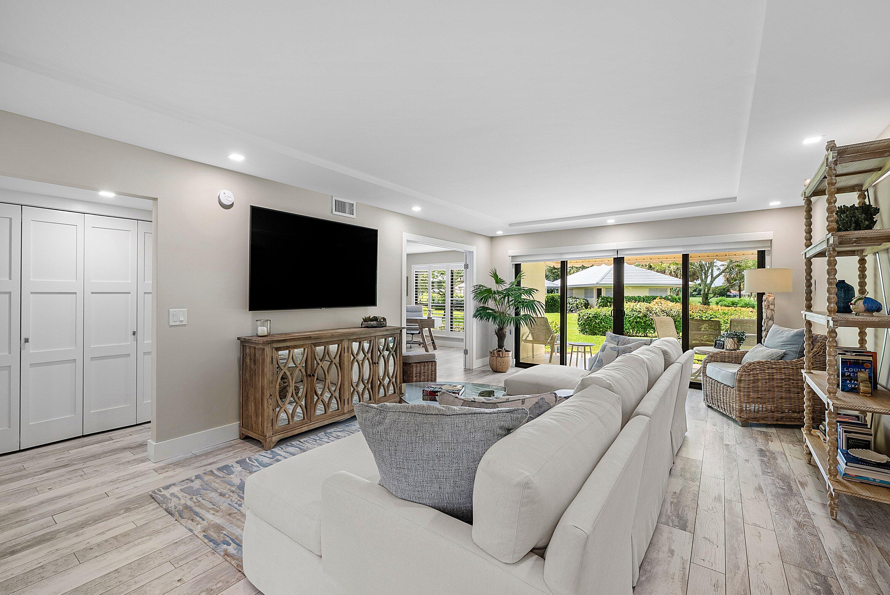 3709 North Quail Ridge Drive, Unit BOBWHITE B Boynton Beach, FL 33436 - Photo 8 of 51 a living room with furniture and a flat screen tv