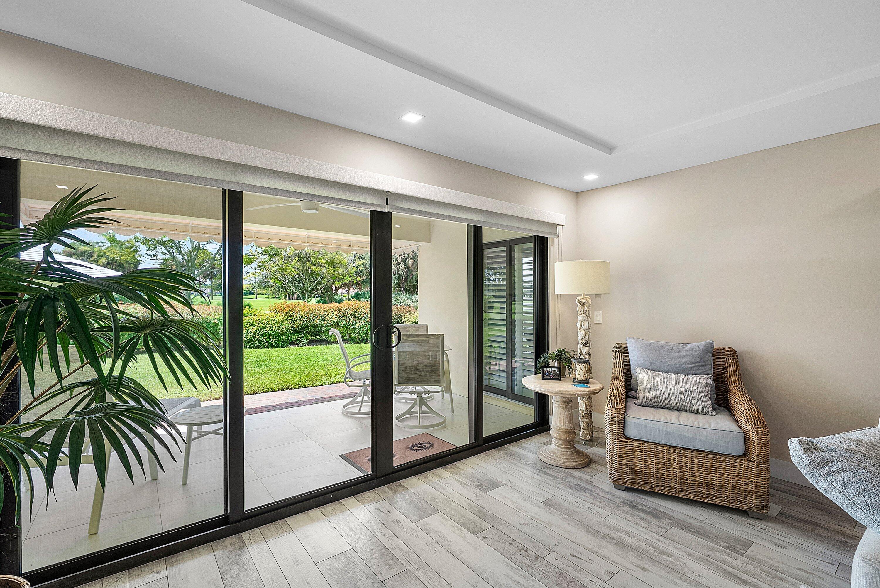 3709 North Quail Ridge Drive, Unit BOBWHITE B Boynton Beach, FL 33436 - Photo 9 of 51 a living room with furniture and a large window