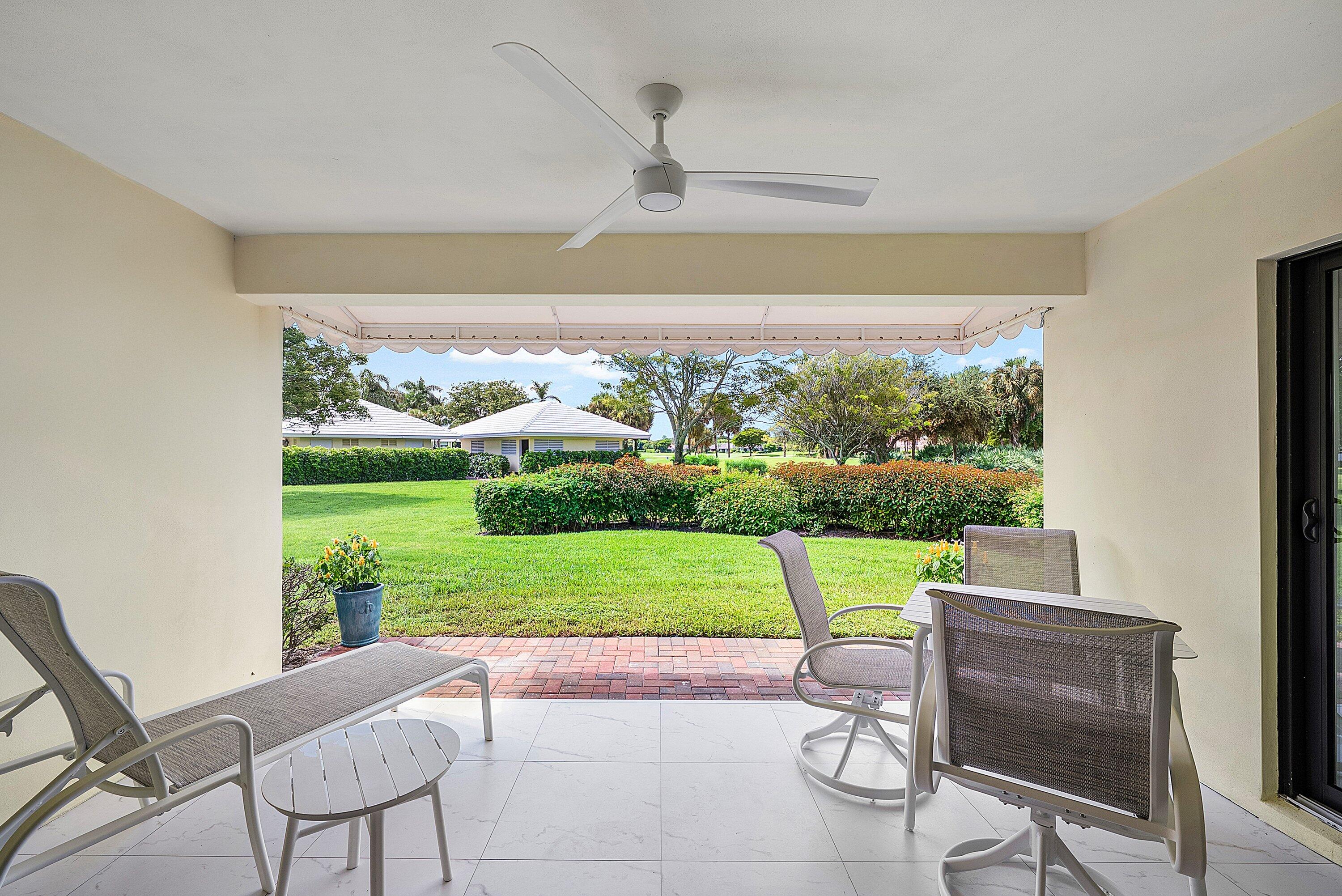 3709 North Quail Ridge Drive, Unit BOBWHITE B Boynton Beach, FL 33436 - Photo 10 of 51 a view of a patio with a yard chairs and a table