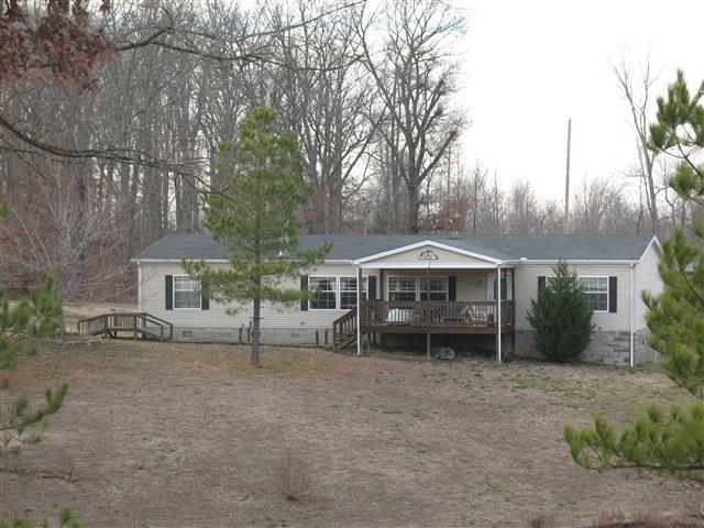 300 Edenway Road Dover, TN 37058 - Photo 1 of 20 Front View of Manufactured Home on permanent foundation on 10 Acres+/-. This home features 2 ponds, fruit trees, outbuilding with workshop and above ground pool.