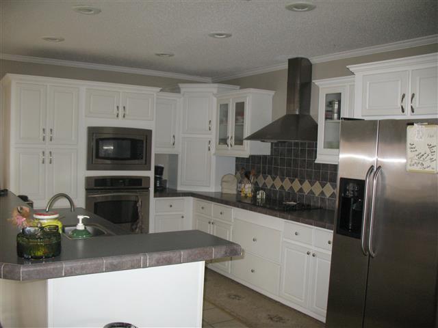 300 Edenway Road Dover, TN 37058 - Photo 11 of 20 Glass front cabinets, nice stove hood, tile back splash and tile flooring.
