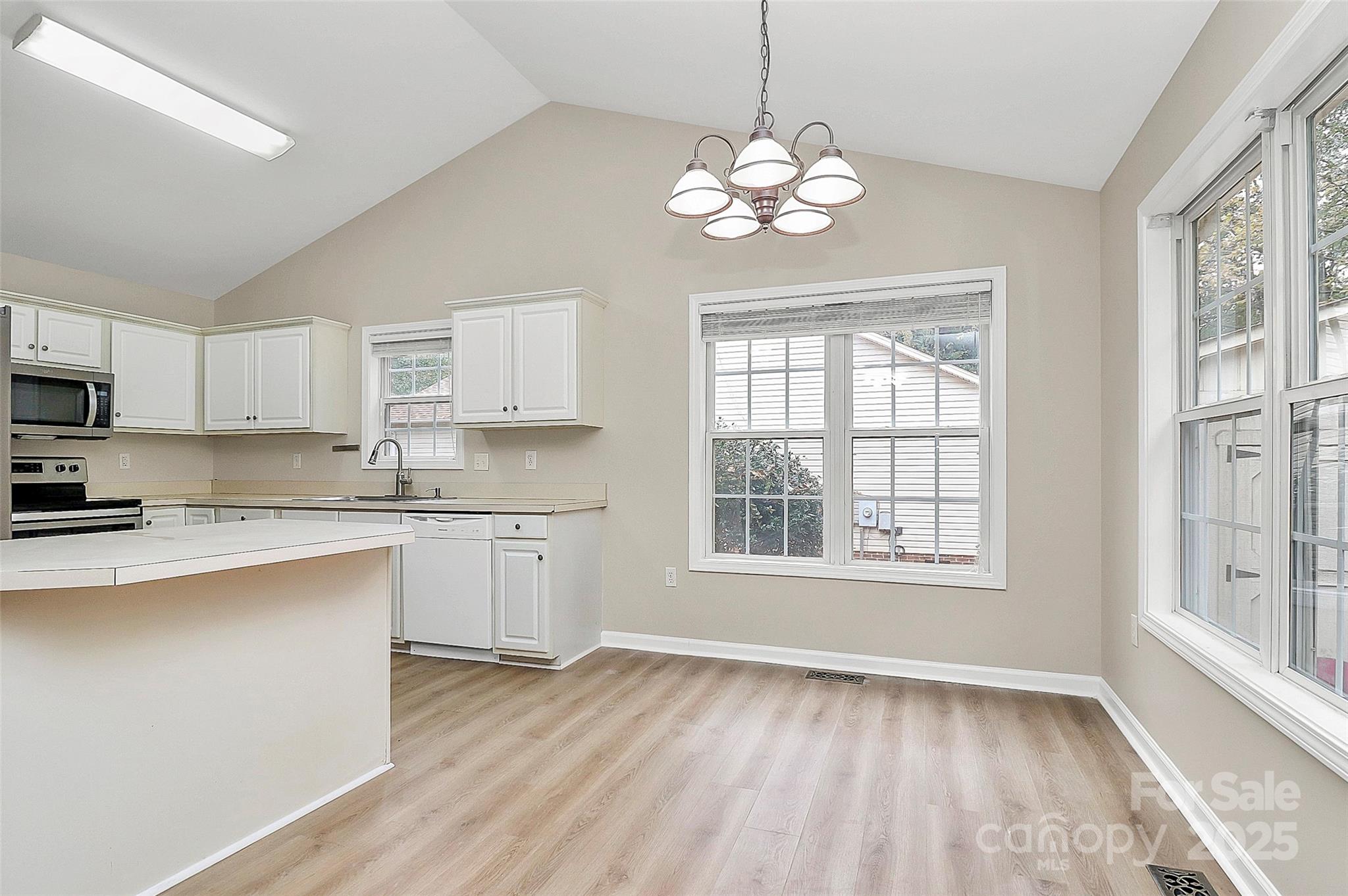103 Wellspring Drive Fort Mill, SC 29715 - Photo 13 of 36 a open kitchen with dishwasher a refrigerator cabinets and a wooden floor