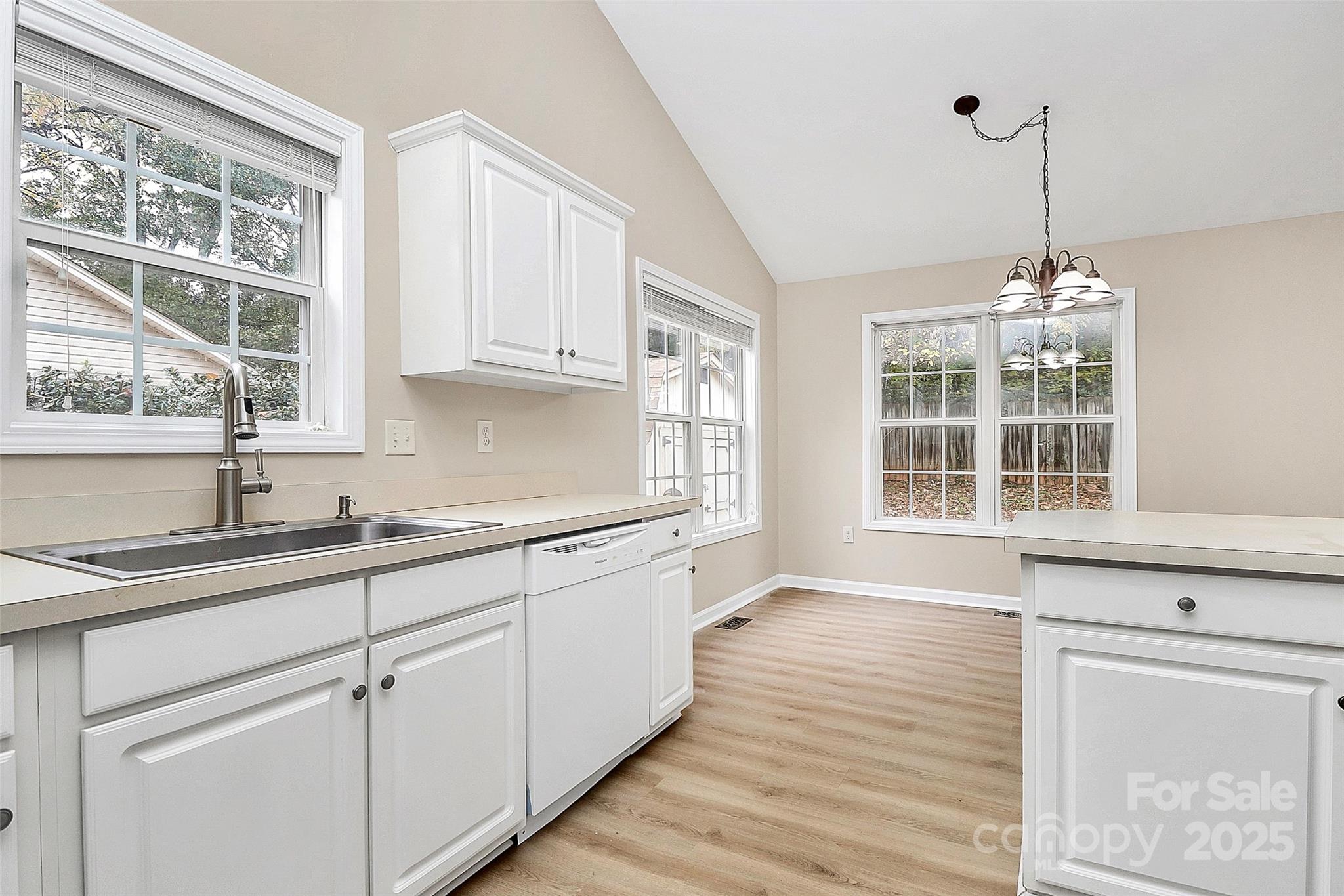 103 Wellspring Drive Fort Mill, SC 29715 - Photo 15 of 36 a kitchen with granite countertop white cabinets and a window