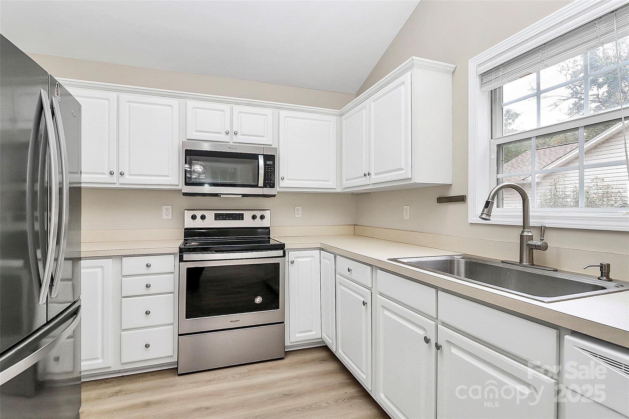 103 Wellspring Drive Fort Mill, SC 29715 - Photo 17 of 36 a kitchen with white cabinets appliances and a sink