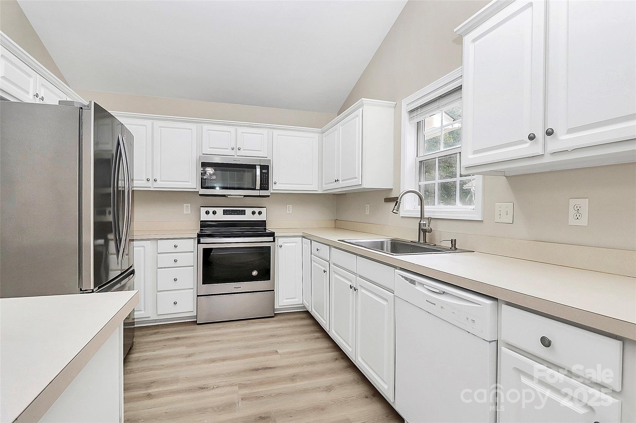 103 Wellspring Drive Fort Mill, SC 29715 - Photo 18 of 36 a kitchen with granite countertop white cabinets and stainless steel appliances