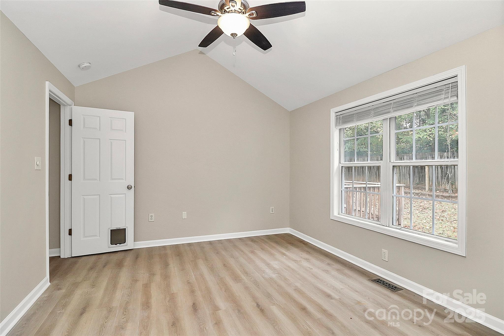 103 Wellspring Drive Fort Mill, SC 29715 - Photo 21 of 36 a view of an empty room with a window and wooden floor