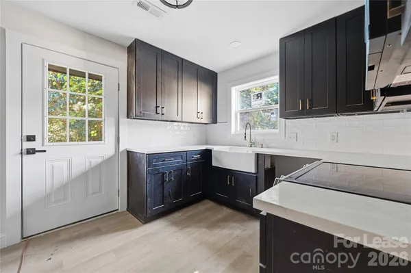 a kitchen with a sink cabinets and window